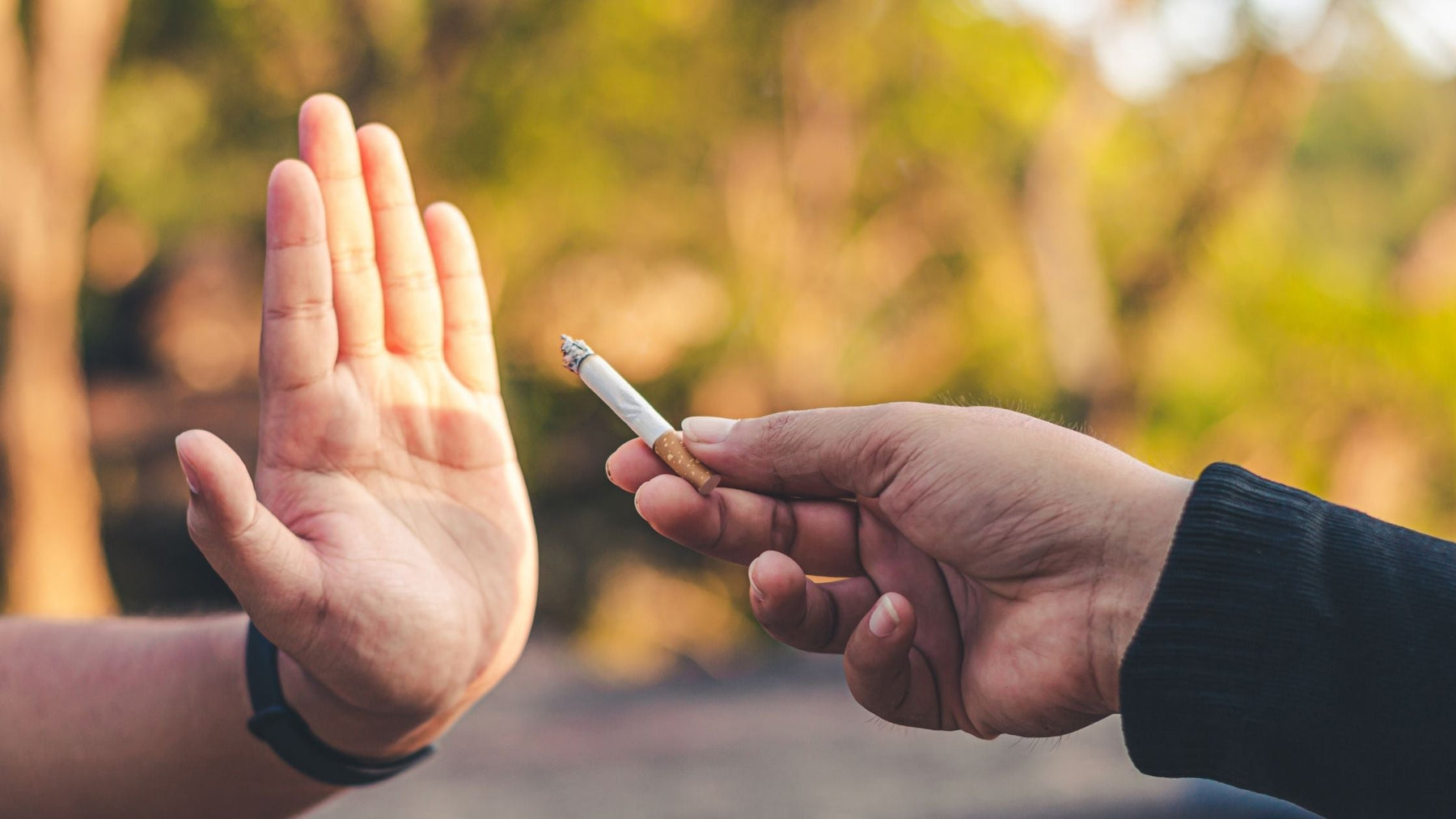 Person refusing a cigarette, symbolising willpower and commitment to quitting smoking and overcoming nicotine cravings.