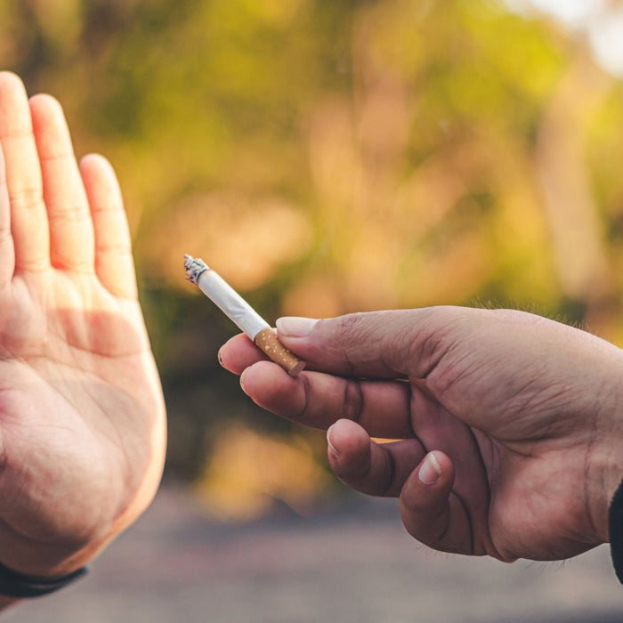 Person refusing a cigarette, symbolising willpower and commitment to quitting smoking and overcoming nicotine cravings.