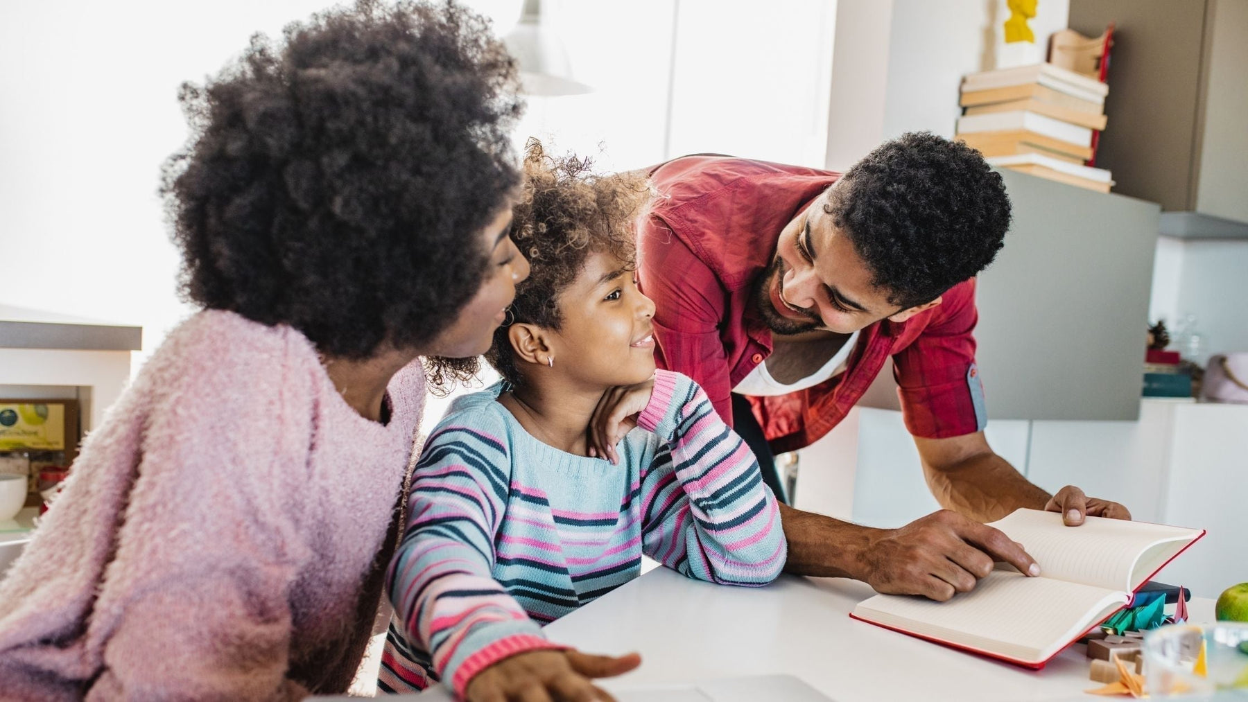 Parents helping their child study at home - supportive family encouraging focus, motivation, and learning during the end-of-year school slump.
