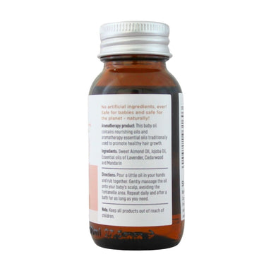  BabyNature Baby Hair Oil Bottle showing ingredients, directions, and claims that it contains no artificial ingredients and is safe for babies.