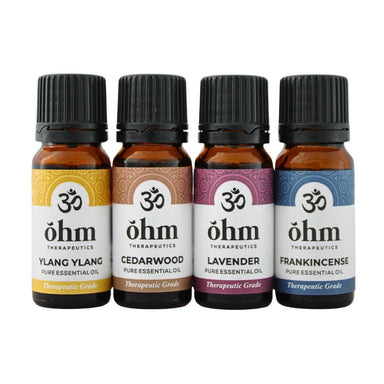Four Ohm Therapeutics essential oils: Ylang Ylang, Cedarwood, Lavender, and Frankincense.